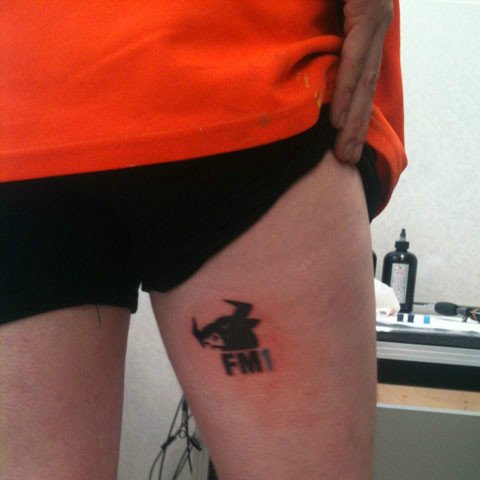 FM1-Logo als Tattoo am Oberschenkel